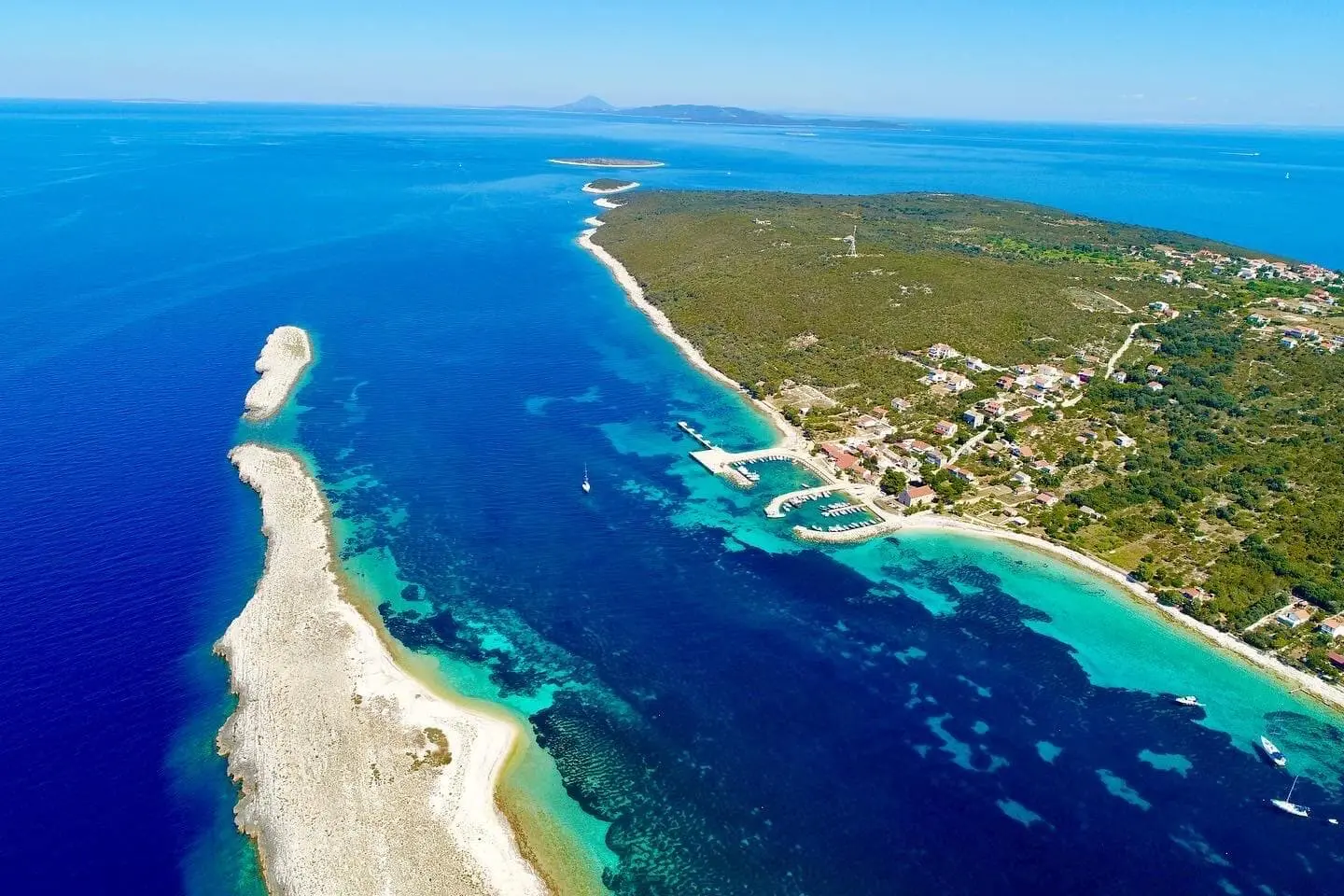 Aerial view of an insland surrounded by deep blue sea